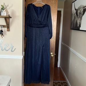 Navy blue floor length formal gown with sparkle details.